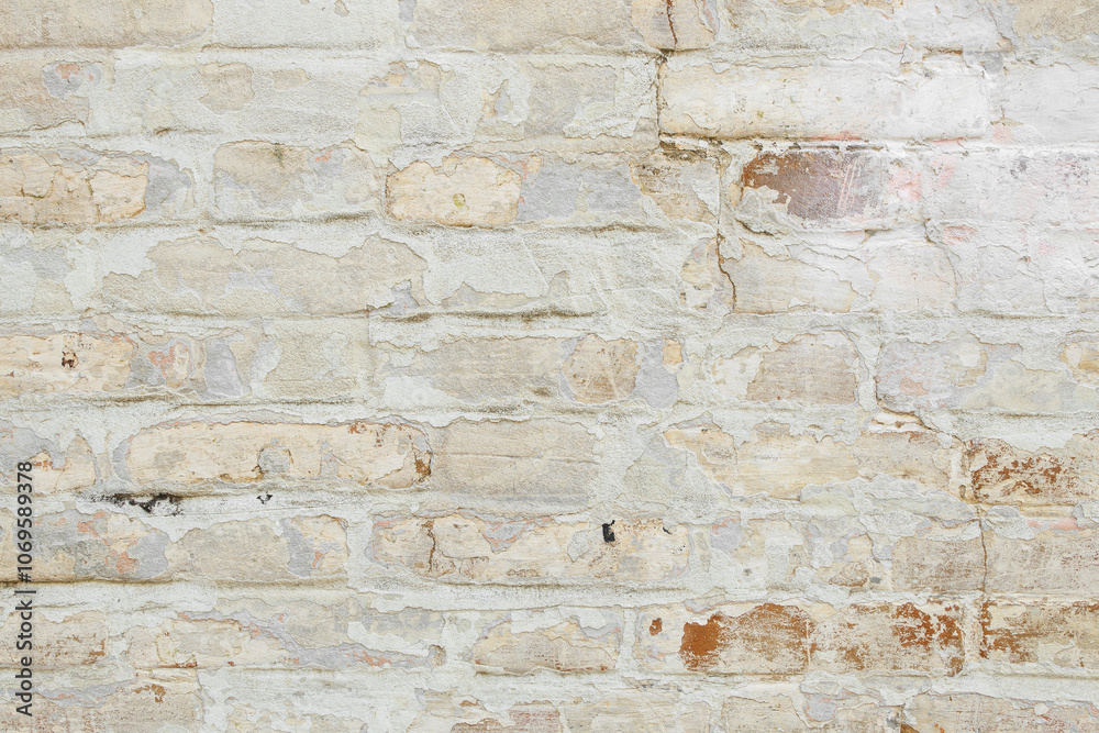 Fototapeta premium Beige grungy brick wall. Free space for an inscription. Can be used as a background or poster. Fragment of a wall with bumps and shabby plaster.