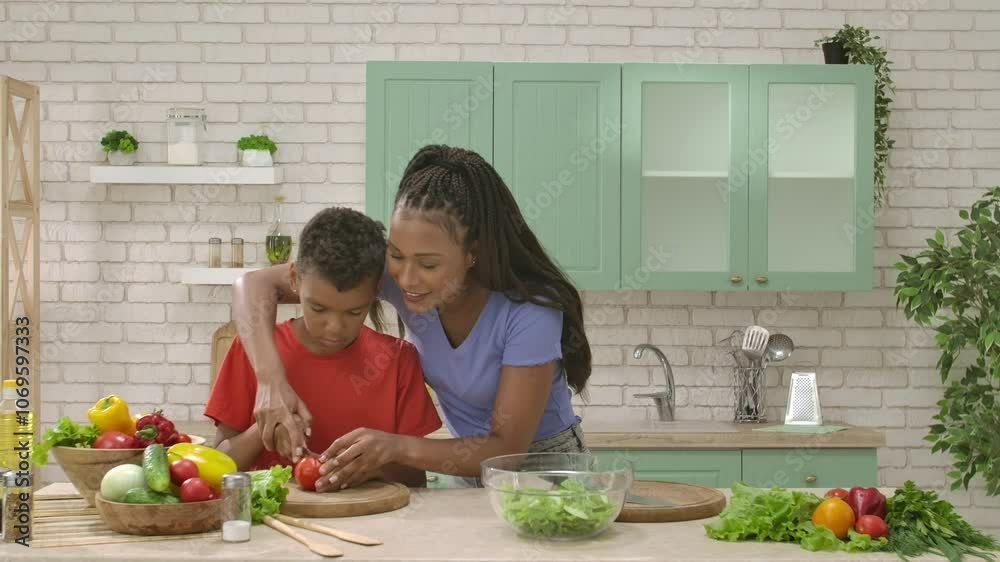 African American happy family preparing food in the kitchen. African American happy family preparing food in the kitchen.