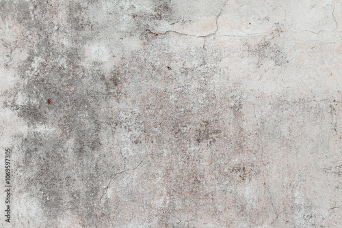 White texture of a concrete wall with natural relief and damage in the form of chips and scratches. Fragment of an old stone surface with a crack. Dark rough surface with a place for an inscription