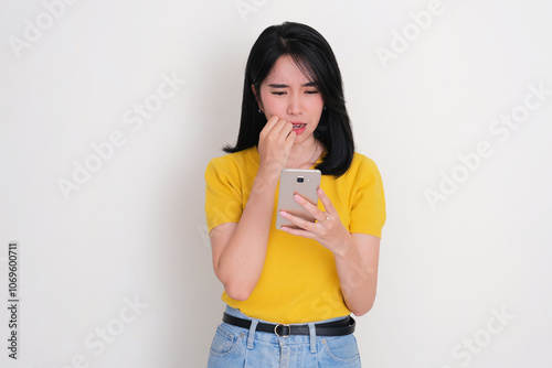 A women staring at her phone with shocked expression photo