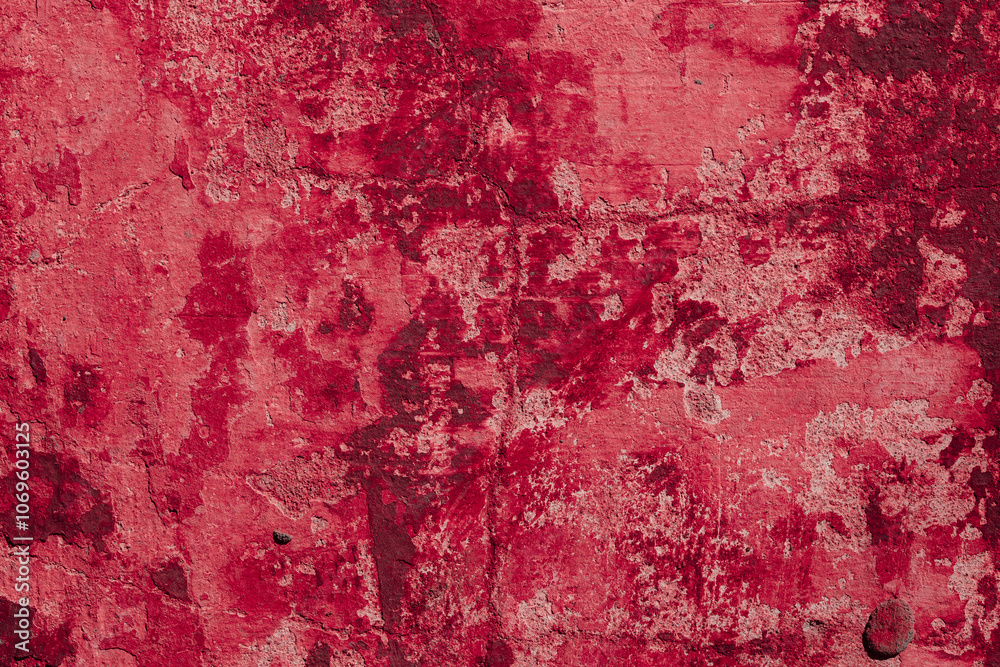Obraz premium Red texture of a concrete wall with natural relief and damage in the form of chips and scratches. Fragment of an old stone surface with a crack. Dark rough surface with a place for an inscription