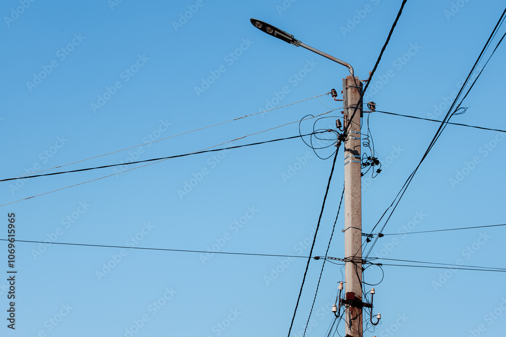 Overhead power lines. Telephone cable. Internet communications. An old post with a bunch of wires. Earth Day. Energy saving concept. The concept of saving electricity bills. Overhead power lines. Telephone cable. Internet communications. An old post with a bunch of wires. Earth Day. Energy saving concept. The concept of saving electricity bills.