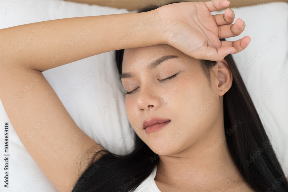 Young Asian woman sleeping on bed and keeping eyes closed while covered with blanket in bedroom. Asian woman sleep and lying on bed in bedroom in the morning. Healthcare concept Young Asian woman sleeping on bed and keeping eyes closed while covered with blanket in bedroom. Asian woman sleep and lying on bed in bedroom in the morning. Healthcare concept