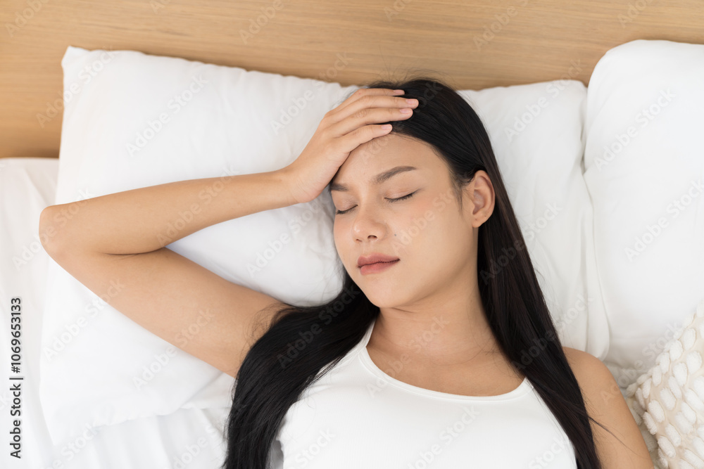 Young Asian woman sleeping on bed and keeping eyes closed while covered with blanket in bedroom. Asian woman sleep and lying on bed in bedroom in the morning. Healthcare concept Young Asian woman sleeping on bed and keeping eyes closed while covered with blanket in bedroom. Asian woman sleep and lying on bed in bedroom in the morning. Healthcare concept