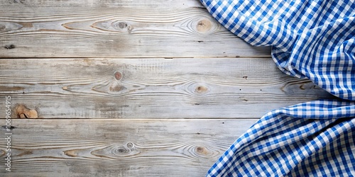 A blue checkered fabric draped over a rustic weathered wooden surface, creating a charming backdrop for culinary creations.