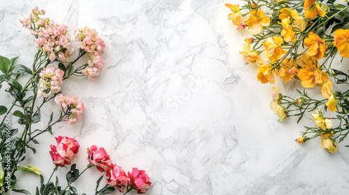 Beautiful arrangement of pink and yellow flowers on marble background, creating vibrant and fresh atmosphere. Perfect for spring themes and floral designs