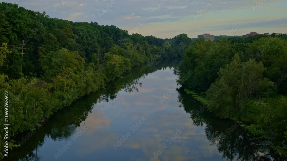 Drone view drifting gently over the Huron River in Ann Arbor, Michigan, in summer. Drone view drifting gently over the Huron River in Ann Arbor, Michigan, in summer.