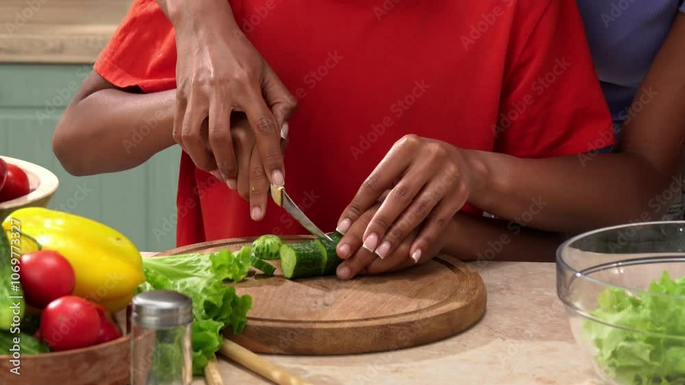 African American happy family preparing food in the kitchen.