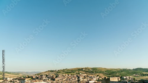 Pietraperzia, Sicily, Italy. Smooth transition from day to night. Panorama of the city with roofs, TimeLapse, Descend photo