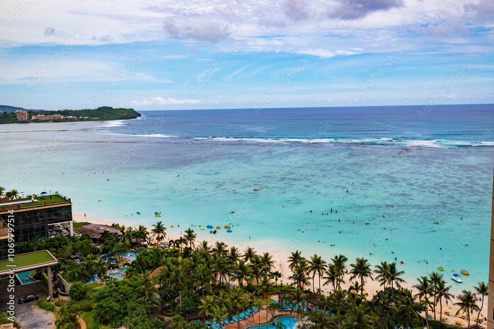 Naklejka premium Breathtaking View of Tumon Bay with Clear Blue Waters and Palm Trees in Guam