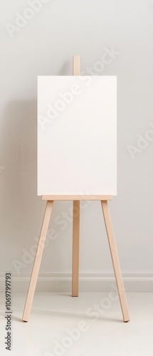 Blank Canvas on Wooden Easel:  A pristine white canvas rests on a simple wooden easel, ready for the artist's vision to take shape. It's an invitation to creativity, a blank slate for inspiration.   photo