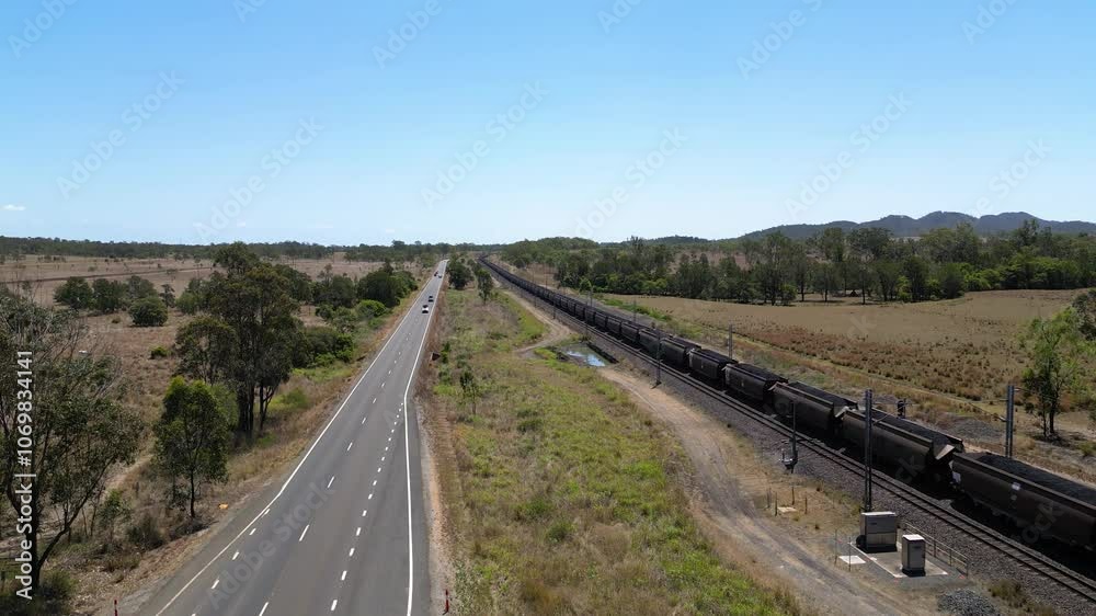 Vertical rising aerial views over a coal train moving towards Gladstone, Central Queensland, Australia Vertical rising aerial views over a coal train moving towards Gladstone, Central Queensland, Australia