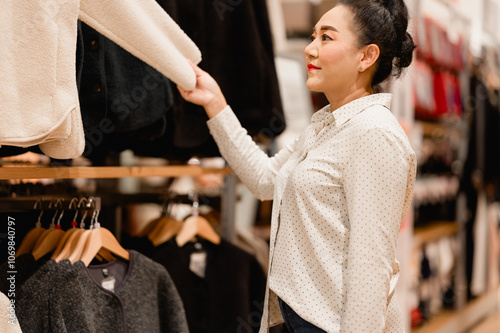 A woman is looking at clothes in a store