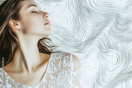 Woman with Closed Eyes and Long Brown Hair Lying on a White Abstract Background photo