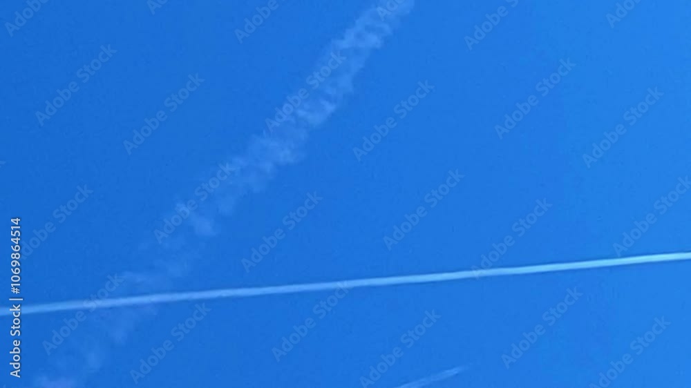 Horizontal Video: Simultaneous trails of several aircraft in the blue sky. Horizontal Video: Simultaneous trails of several aircraft in the blue sky.