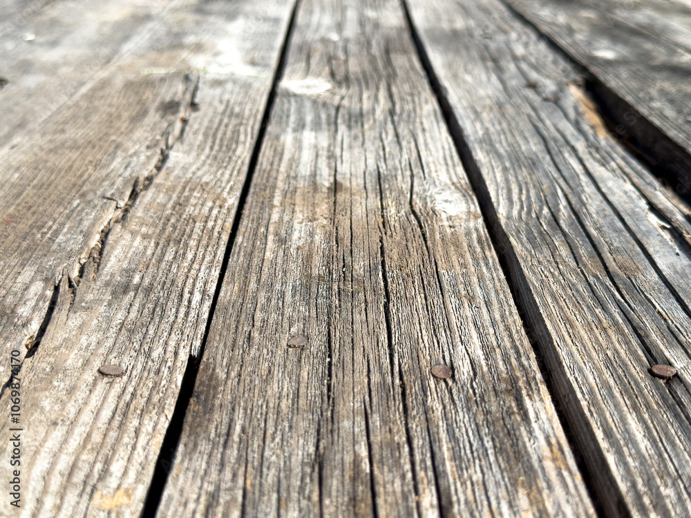 The image is of a wooden floor with a grainy texture The image is of a wooden floor with a grainy texture