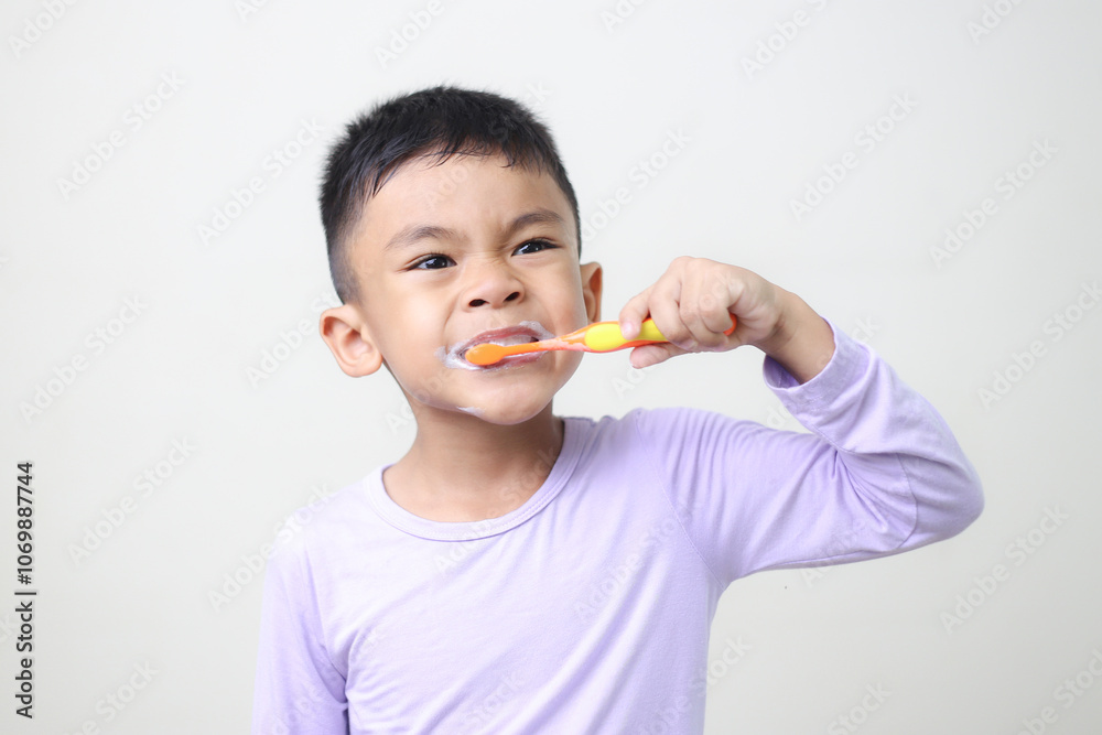 child Asia kid boy brushing teeth isolated on white backgroud.