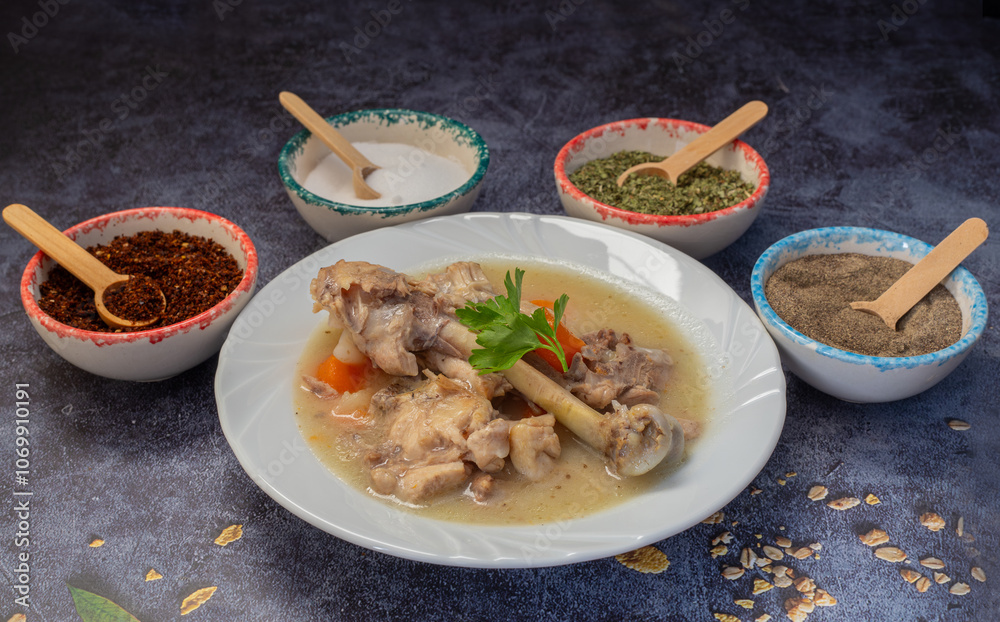 Boiled chicken thighs with potatoes and carrots in a white plate. Boiled chicken meat.
