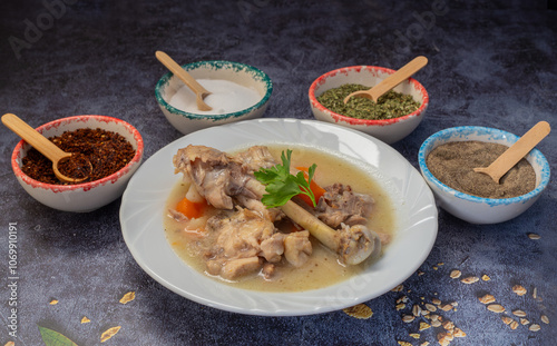 Obraz na płótnie Boiled chicken thighs with potatoes and carrots in a white plate. Boiled chicken meat. w salonie