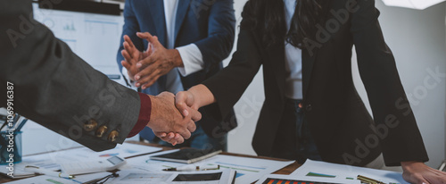 Holding hands, agreeing to invest in business together Colleagues clapping congratulations in the office. Teamwork concept succeeds in business. photo