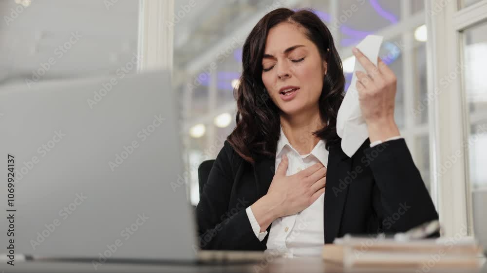 Stressed businesswoman in office feeling unwell with tissue wiping sweat and coughing. 4K corporate burnout or anxiety concept video. Stressed businesswoman in office feeling unwell with tissue wiping sweat and coughing. 4K corporate burnout or anxiety concept video.