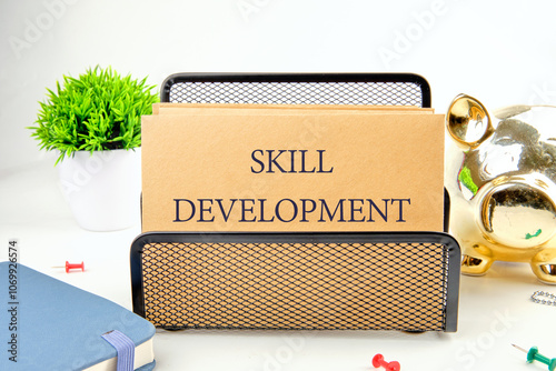 Business concept. The phrase, the text, the word SKILL DEVELOPMENT is written on paper in a black stand on a light background