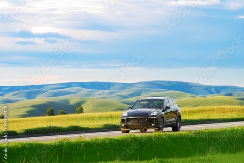 Luxury black SUV driving on a country road during sunset