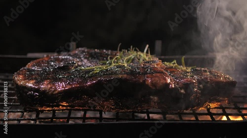 Juicy Juicy steak with rosemary is grilled. Close-up.