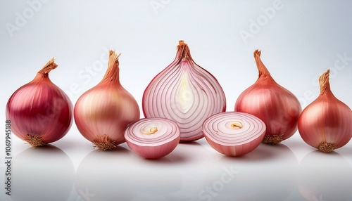 Fresh shallots, whole and sliced, arranged neatly in rows on a clean background.