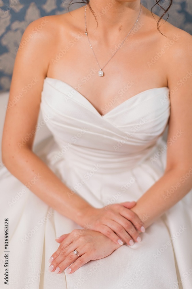Bride in elegant white gown with pearl necklace and ring. Bride in elegant white gown with pearl necklace and ring.