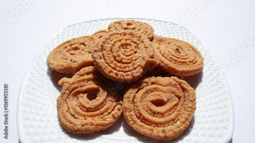 Crunchy fried homemade Chakli in a plate. Chakli is a savory snack from India. Diwali festival Indian snack called Chakli photo