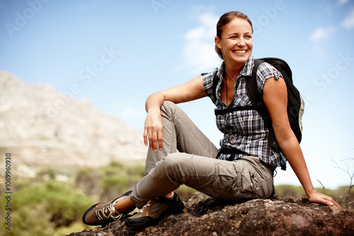 Woman, outdoor hiking and thinking on mountain, holiday adventure and contemplating future on trip. Female person, rock and relax on vacation to dream of journey, location and trekking break on cliff photo