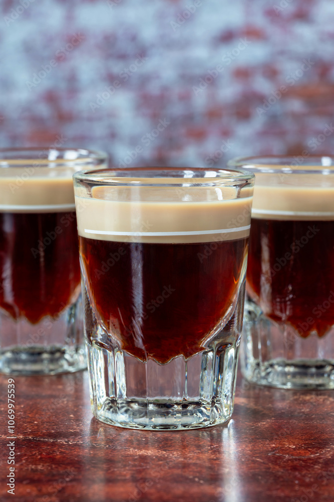 St. Patrick’s Day cocktail of layered Irish cream and coffee liqueur made to look like mini stout shot St. Patrick’s Day cocktail of layered Irish cream and coffee liqueur made to look like mini stout shot