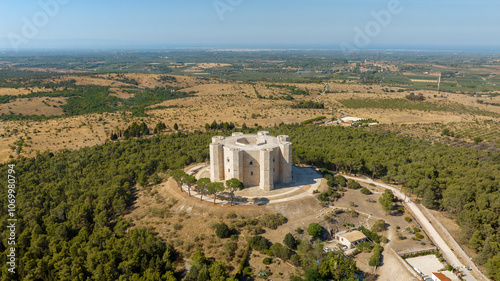 Aerial view of Castel del Monte. It is a castle situated on a hill near Andria, in Puglia, Italy. A medieval fortress built in the Middle Ages by Frederick II. In background is the Adriatic sea.