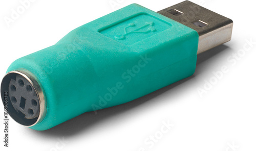 closeup of ps2 to usb converter isolated white background, green color small adapter use to connect older keyboards and mouse to modern usb ports