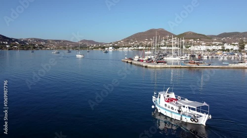 Aerial over Touristic Tour Boat Leaving Parikia Port, Greece photo