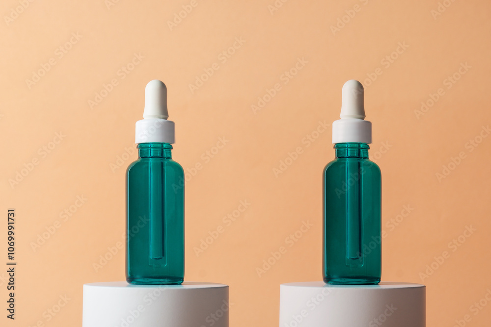 Blue glass cosmetic bottle, Skin care or sunscreen cosmetic with stylish props on cream background. Blue glass cosmetic bottle, Skin care or sunscreen cosmetic with stylish props on cream background.