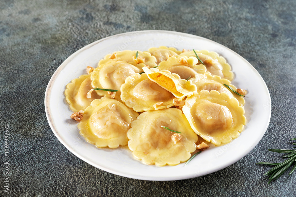 Ravioli pasta filled with pumpkin, nuts and fresh herbs on white background. Ravioli pasta filled with pumpkin, nuts and fresh herbs on white background.