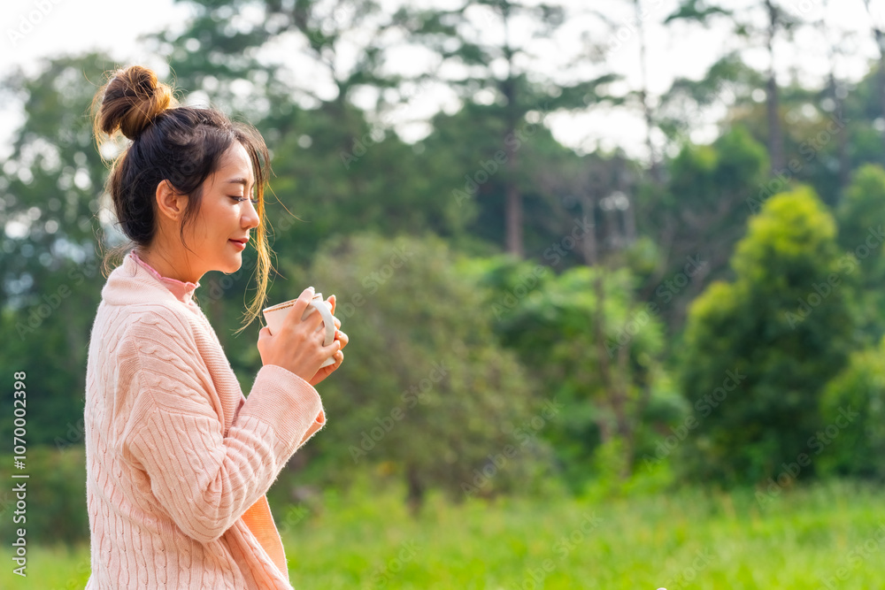 Beautiful Asian woman sit on terrace and drinking hot coffee during camping at forest mountain in the morning. Healthy girl relax and enjoy outdoor active lifestyle travel nature on holiday vacation. Beautiful Asian woman sit on terrace and drinking hot coffee during camping at forest mountain in the morning. Healthy girl relax and enjoy outdoor active lifestyle travel nature on holiday vacation.