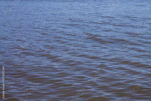 Blue water surface with ripples and waves. Water surface background.