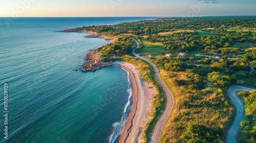 Aerial view of a winding road along a picturesque coastline.