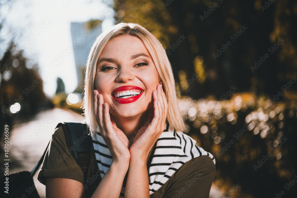 Photo of pretty young blonde woman cheerful smile wear khaki clothes tied shoulders sweater walk outside urban city park Photo of pretty young blonde woman cheerful smile wear khaki clothes tied shoulders sweater walk outside urban city park