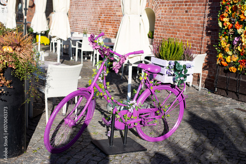 a purple bike decorated with flowers