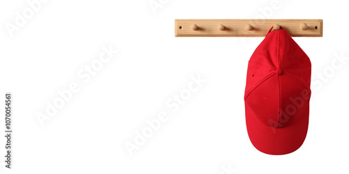 Photography red baseball cap hangs on a wooden clothes rack, isolated on a white background and a copy space
