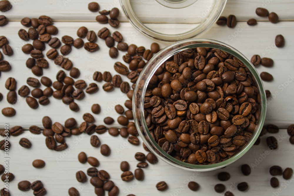 Jar with coffee beans on white table Jar with coffee beans on white table