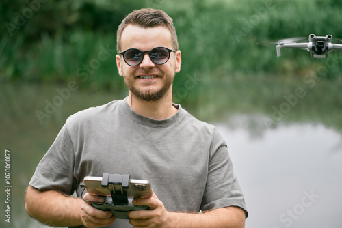 Happy man flying drone outside