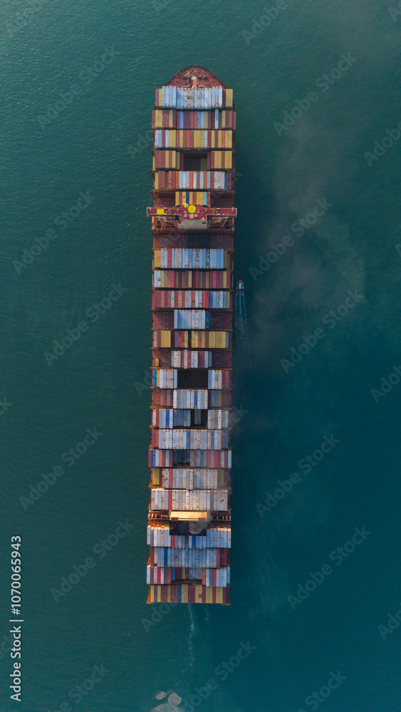 Fototapeta premium Logistics and container loading by large barges by sea in a harbor full of containers waiting to be transported..