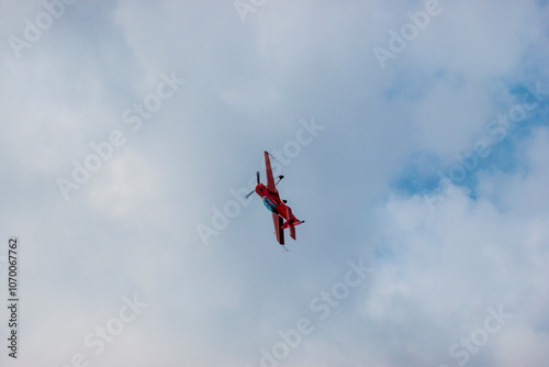 A pilot flies an aerobatic propeller plane in the sky