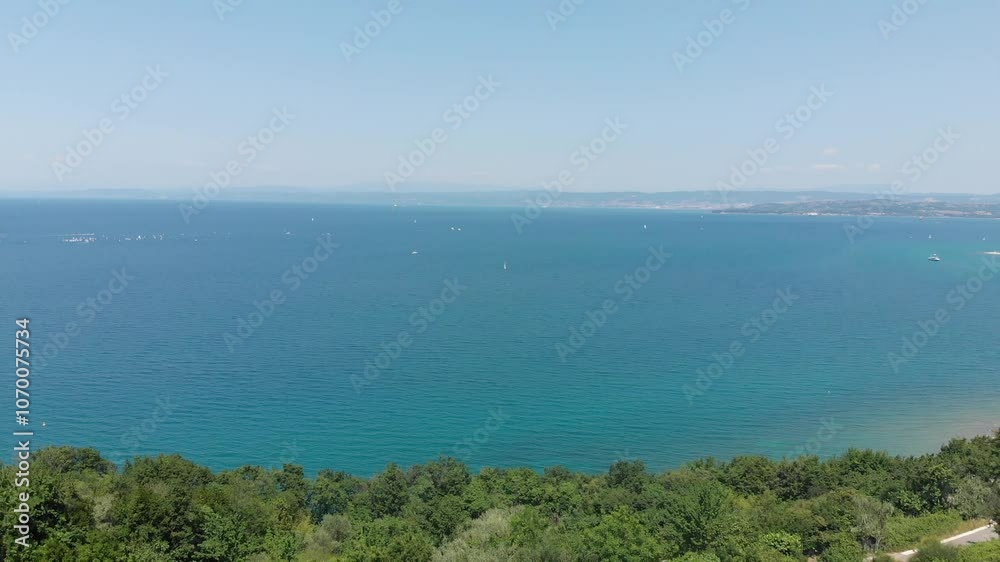 aerial view of slovenian coastline, drone flying backwards above sea and olive grove aerial view of slovenian coastline, drone flying backwards above sea and olive grove