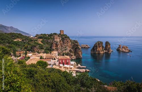 Cliffs on the coast in summer in Scopello near of Castellammare del Golfo in Sicily, Italy. June 2023, long exposure picture, sunrise time.